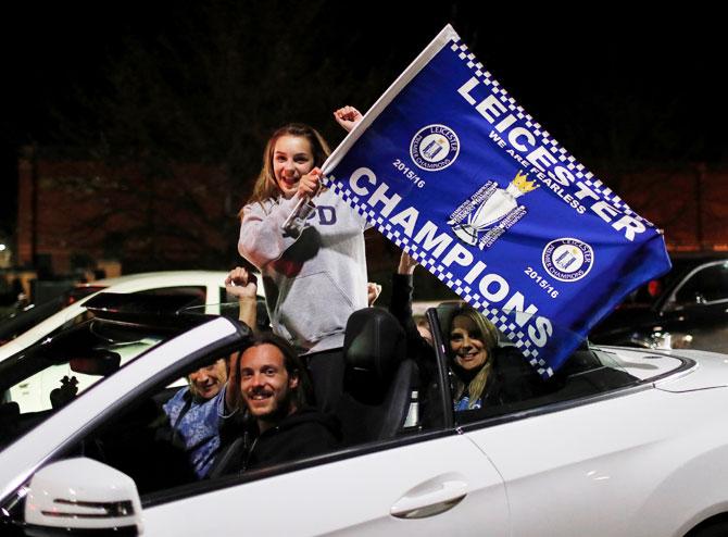 Leicester City fans celebrate outside the King Power stadium 