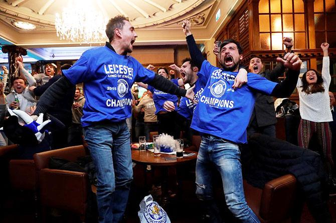  Leicester City fans celebrate after Chelsea scored the second goal against Spurs on Monday