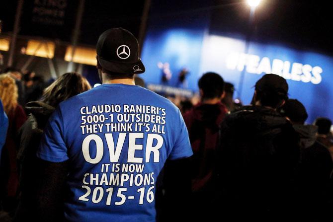 Leicester City fans celebrate outside the King Power stadium after their team won the Premier League title in Leicester