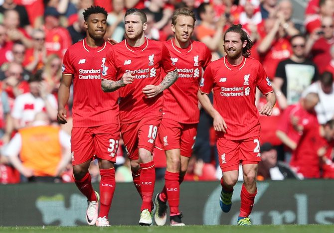 Joe Allen of Liverpool (right) celebrates with his teammates after scoring the opening goal against Watford during their Barclays English Premier League match at Anfield in Liverpool on Sunday