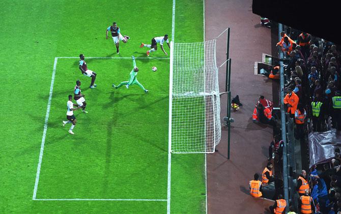 Manchester United's Anthony Martial (right) scores their second goal past West Ham United's goalkeepr Darren Randolph