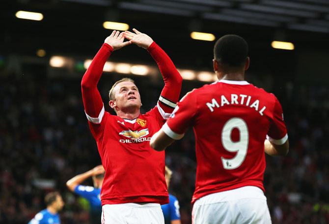 Manchester United's Wayne Rooney celebrates with teammate Anthony Martial as he scores their first goal against AFC Bournemouth during the Barclays Premier League match at Old Trafford on Tuesday