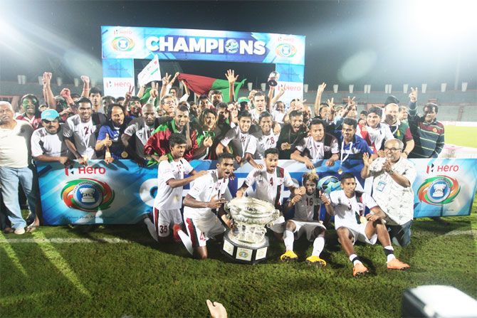 Mohun Bagan players and officials celebrate with the Fed Cup trophy on Saturday