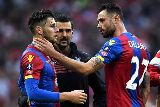Crystal Palace's Joel Ward (left) is consoled by teammate Damien Delaney as he show his emotions in defeat