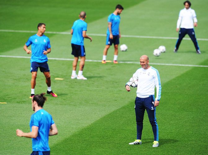 Real Madrid manager Zinedine Zidane watches over a team training session