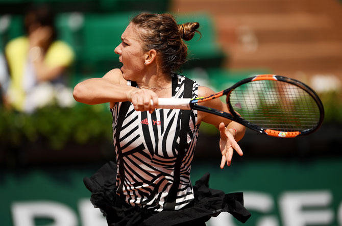 Romania's Simona Halep whips a return against Japan's Naomi Osaka during their French Open third round match at the Roland Garros on Friday