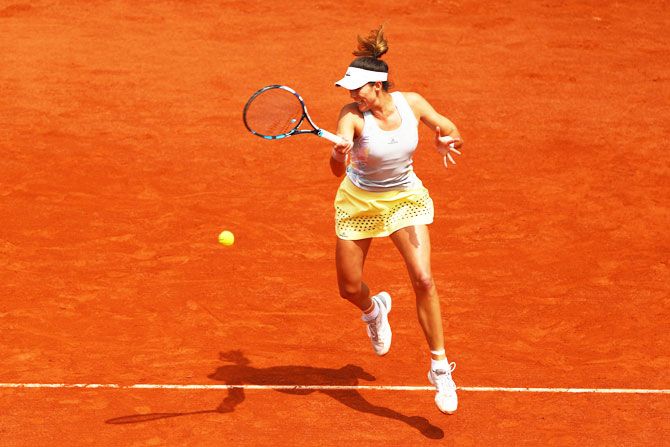 Spain's Garbine Muguruza hits a forehand against France's Myrtille Georges during their French Open second round match