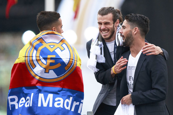 Gareth Bale (2nd from left) and teammates Isco (right) and Lucas Vazquez (left) share a laugh
