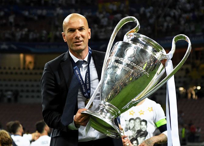 Real Madrid head coach Zinedine Zidane with the Champions League trophy after their win at the San Siro in Milan on Saturday