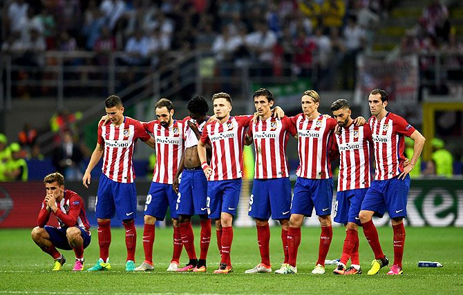 Atletico Madrid players look on during the penalty shoot out during the UEFA Champions League final against Real Madrid at Stadio Giuseppe Meazza in Milan on Saturday