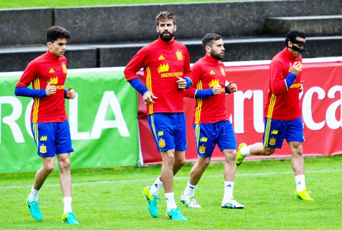 (Left-Right) Marc Bartra, Gerard Pique, Jordi Alba and Pedro Rodriguez warm-up at a training session