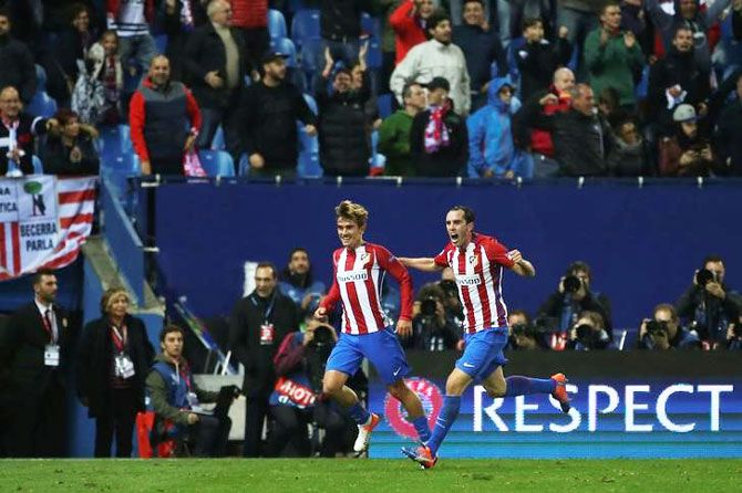 Atletico Madrid's Antoine Griezmann celebrates his goal with teammate Diego Godin during their UEFA Champions League match against Rostov at Vicente Calderon stadium, Madrid, on Tuesday