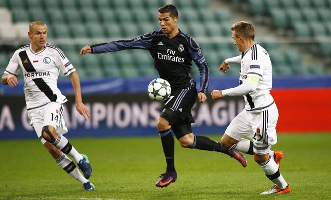 Madrid's Cristiano Ronaldo is challeged by Warsaw's Michal Kopczynski and Adam Hlousek during their Champions League match at Polish Army Stadium in Warsaw on Wednesday