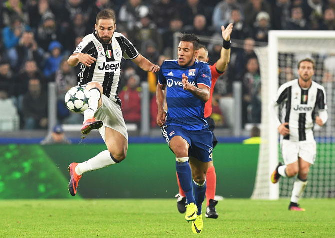Juventus's Gonzalo Higuain controls the ball and runs past Olympique Lyonnais' Corentin Tolisso during their UEFA Champions League Group H match at Juventus Stadium in Turin, Italy, on Wednesday