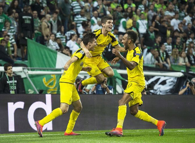 Borussia Dortmund's Julian Weigl (left) celebrates with teammates after scoring against SC Sporting Lisbon at Estadio Jose Alvalade in Lisbon on Wednesday