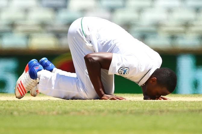 South Africa's Kagiso Rabada kisses the pitch after taking his fifth wicket of the innings on Day 5 of the First Test against Australia at the WACA in Perth on Monday