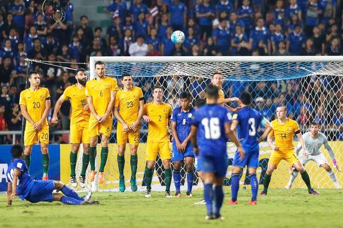 Thailand's Teerasil Dangda (left) has his free kick blocked by the Australian wall during their World Cup qualifier in Rajamangala National Stadium, Bangkok, on Tuesday