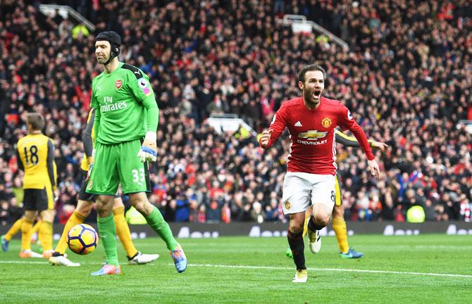 Manchester United's Juan Mata (right) celebrates scoring against Arsenal