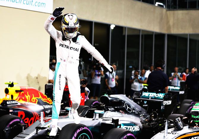 Lewis Hamilton of Great Britain and Mercedes GP waves to the crowd after qualifying on pole position during qualifying for the Abu Dhabi Formula One Grand Prix at Yas Marina Circuit in Abu Dhabi on Saturday