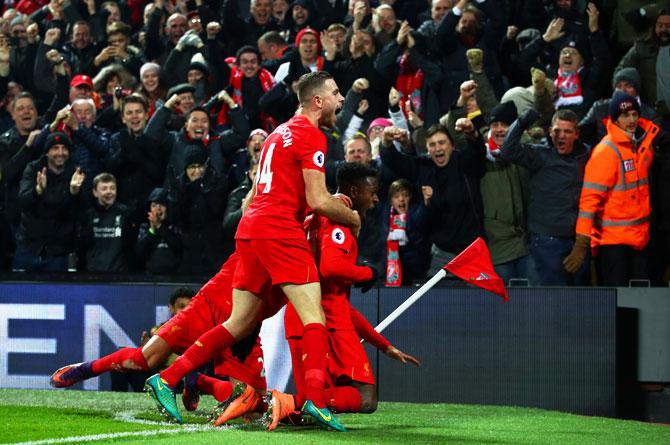 Liverpool's Divock Origi (1st right) celebrates with teammates on scoring the opening goal against Sunderland during their Premier League match at Anfield in Liverpool on Saturday