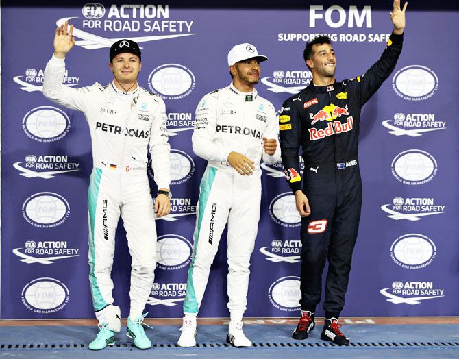 Top three qualifiers, Mercedes GP's Lewis Hamilton and Nico Rosberg with Red Bull Racing's Daniel Ricciardo in parc ferme after qualfying on Saturday