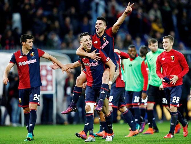 Genoa's Lucas Ocampos and Giovanni Simeone celebrate at the the end of the match after defeating Juventus on Sunday