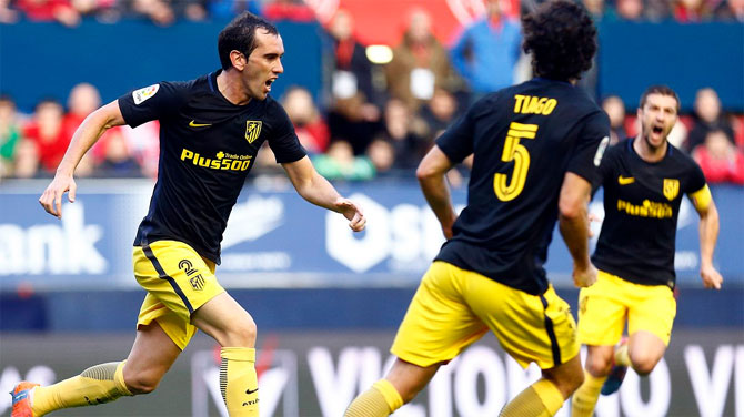 Atletico Madrid's Diego Godin celebrates a goal with teammates during their La Liga match against Osasuna on Sunday