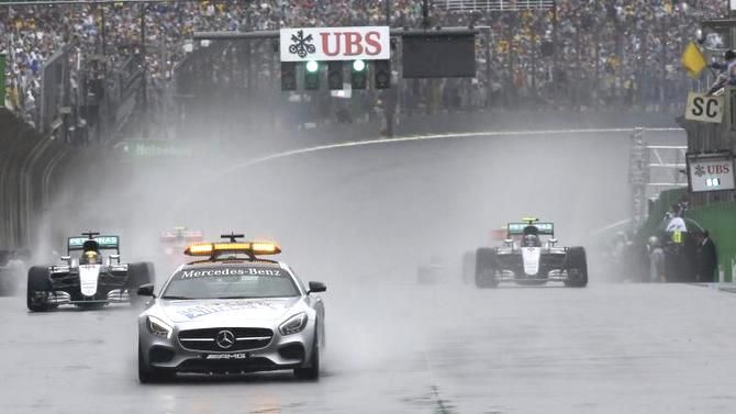 Mercedes' Lewis Hamilton of Britain (left) follows the safety car at the start of the Brazilian GP F1 race at the Circuit of Interlagos in Sao Paulo on Sunday