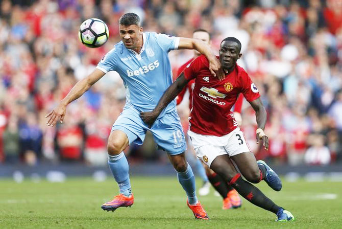 Stoke City's Jonathan Walters is challenged by Manchester United's Eric Bailly