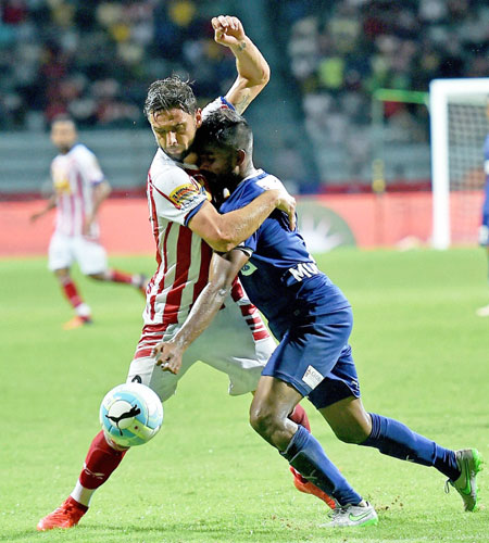 Atletico de Kolkata and Chennaiyin FC players vie for the ball during their ISL match in Kolkata on Sunday