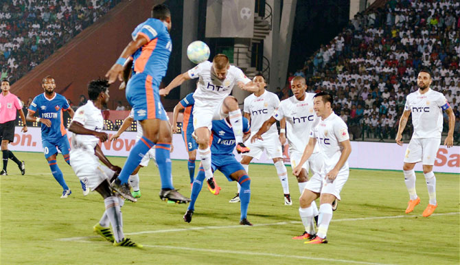 Players of Northeast United FC and FC Goa vie for an aerial ball during their ISL match at Indira Gandhi Athletics Stadium in Guwahati on Tuesday
