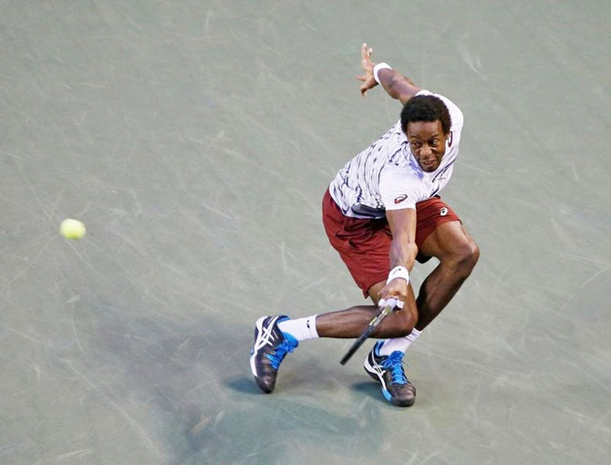 France's Gael Monfils returns a ball to Croatia's Ivo Karlovic during their men's singles quarters at the Ariake Coliseum, in Tokyo, on Friday
