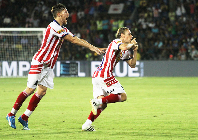 Atletico de Kolkata's Javier Lara (riight) celebrates with a teammate after netting the equaliser against Mumbai City FC in Mumbai on Tuesday