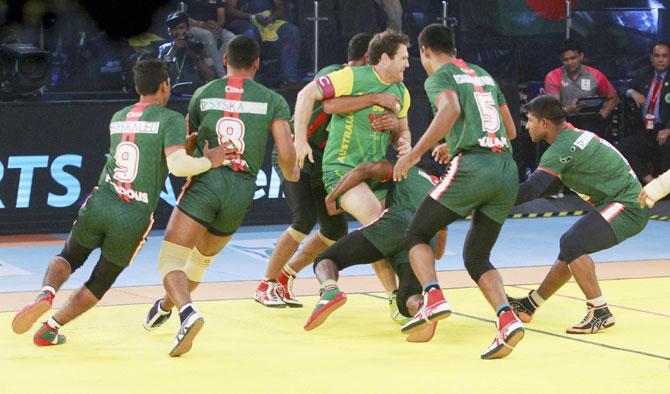 Bangladesh kabaddi team player catch raider of Australia kabaddi team player during kabaddi world cup match in Ahmadabad on Monday