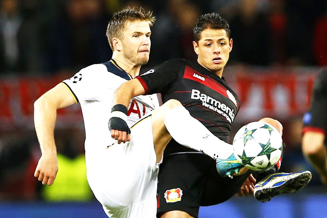 Bayer Leverkusen's Javier Hernandez and with Tottenham's Eric Dier vie for possession