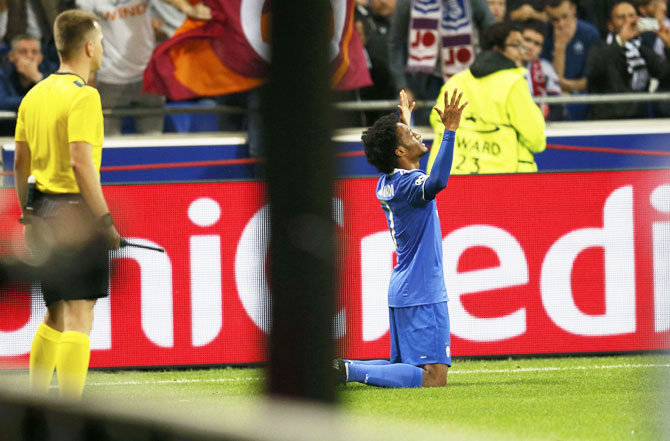 Juventus' Juan Cuadrado celebrates after scoring against Olympique Lyon at Stade de Lyon in Decines, France