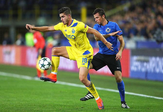 Andre Silva of FC Porto and Claudemir of Club Brugge compete for the ball during their UEFA Champions League Group G match at Jan Breydel Stadium in Bruges, Belgium