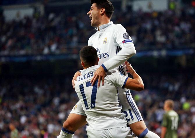 Real Madrid's Lucas Vazquez celebrates with teammate Alvaro Morata after scoring a goal against Legia Warsaw at Santiago Bernabeu stadium, Madrid, on Tuesday