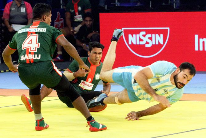 Bangladesh players catch a Argentina player during the Kabaddi World Cup in Ahmedabad on Wednesday