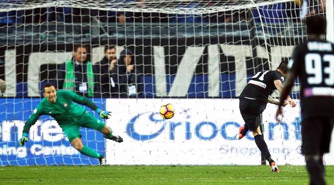 Atalanta's Mauricio Pinilla shoots to score a penalty against Inter Milan on Sunday