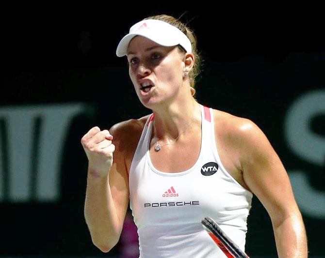 Germany's Angelique Kerber celebrates a point against Slovakia's Dominika Cibulkova during their WTA Finals opener at the National Indoor Stadium in Singapore on Sunday