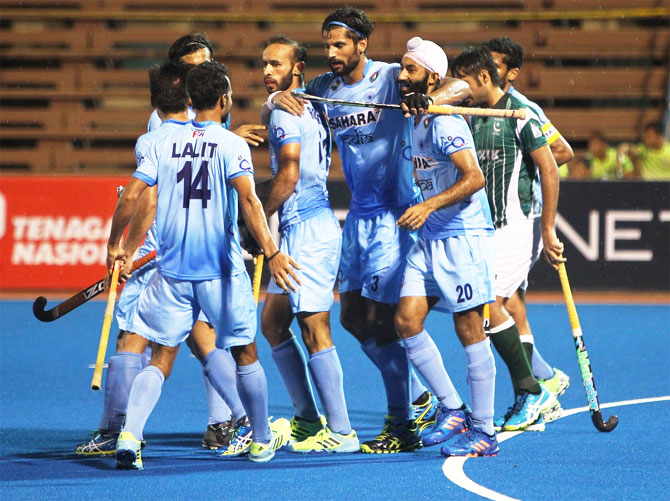 India's Rupinder Pal Singh celebrates with teammates after scoring the 2nd goal against Pakistan on Sunday