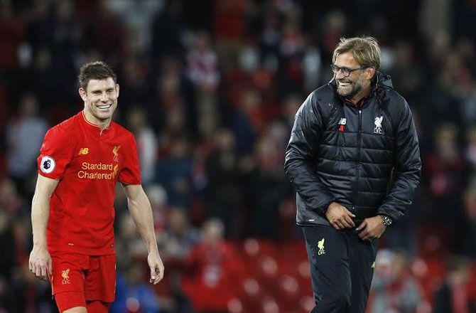 Liverpool manager Juergen Klopp celebrates with James Milner after the game