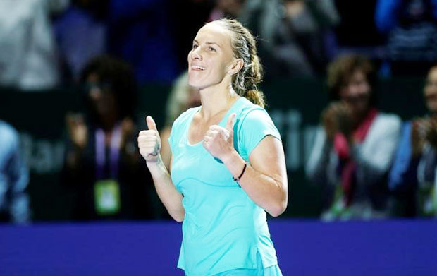 Russia's Svetlana Kuznetsova celebrates after defeating Poland's Agnieszka Radwanska during their WTA Finals Round Robin Singles match at the National Indoor Stadium, Singapore, on Monday