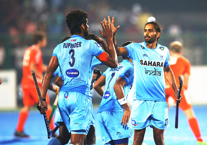 India's Rupinder Pal Singh celebrates scoring with Akashdeep Singh