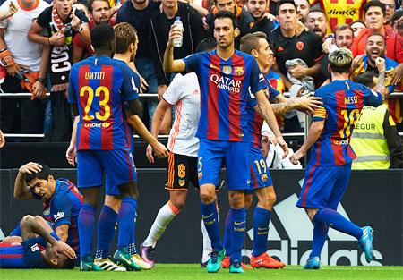 FC Barcelona's Luis Suarez and Neymar grimace in pain after being hit by a plastic bottle during their La Liga match against Valencia on Saturday