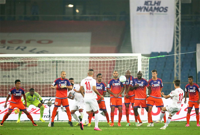 The Pune FC defence wall is all focus as Marcelo Pereira of Delhi Dynamos FC takes a free kick during their ISL match in New Delhi on Thursday