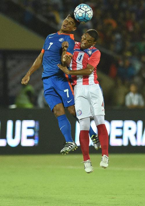 India's Eugeneson Lyngdoh and a Puerto Rican player vie for an aerial ball during their football friendly in Mumbai on Saturday