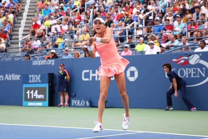 Agnieszka Radwanska of Poland plays a return against Caroline Garcia of France