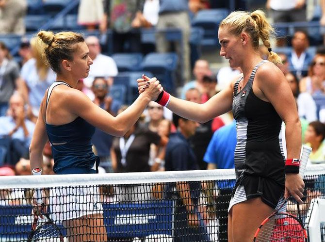 Simona Halep is congratulated by Timea Babos after their match